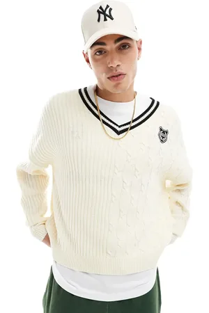 ASOS Oversized boxy fit contrast cable knitted jumper with varsity badge in cream