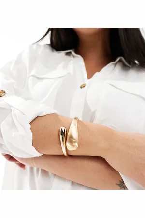 ASOS ASOS DESIGN Curve cuff bracelet with wrap around molten detail with shiny and brushed tone