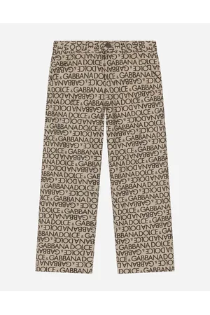 Dolce & Gabbana Hosen und Shorts - Hose aus bedrucktem Denim mit Allover-Logo
